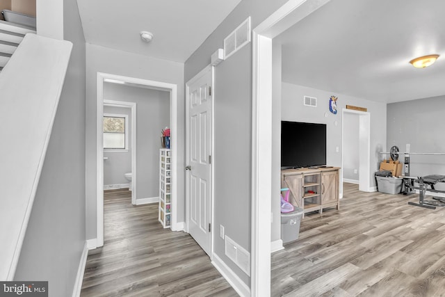 hallway with light hardwood / wood-style floors