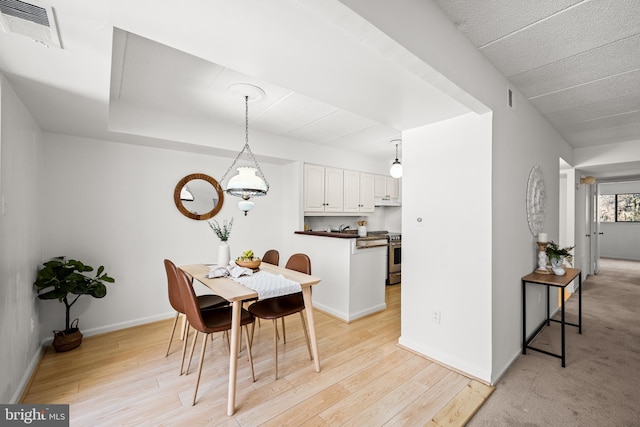 dining area with light wood-type flooring