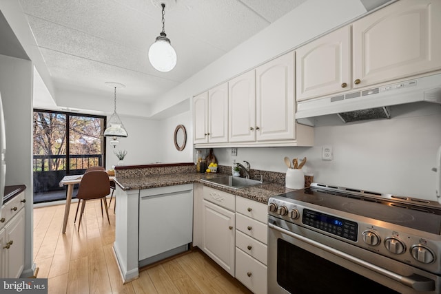 kitchen with kitchen peninsula, pendant lighting, white cabinetry, and stainless steel range with electric cooktop