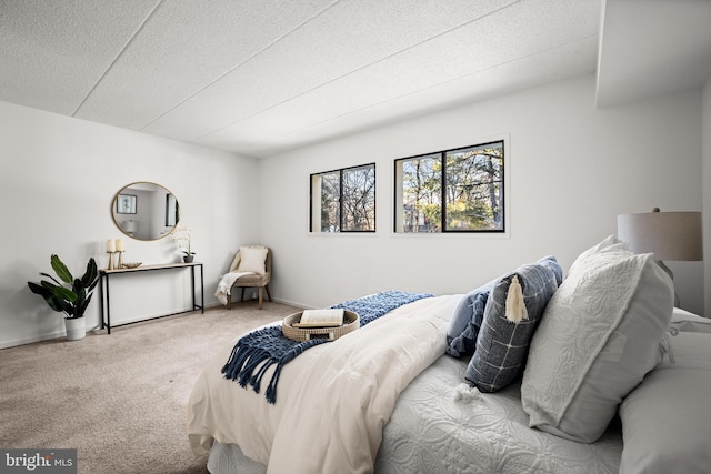 carpeted bedroom featuring a textured ceiling