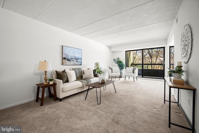 carpeted living room featuring a textured ceiling