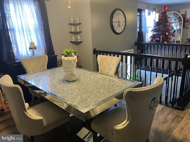 dining space with dark hardwood / wood-style flooring