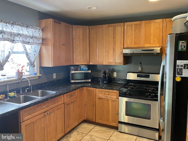 kitchen featuring light tile patterned flooring, stainless steel appliances, and sink