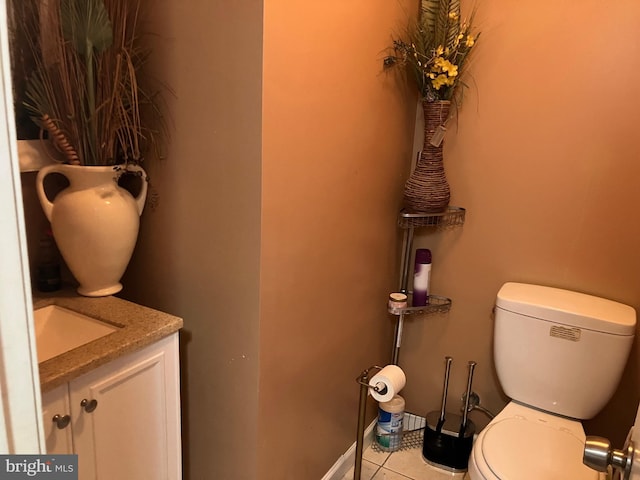 bathroom featuring vanity, tile patterned floors, and toilet