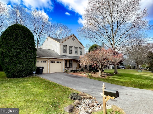 view of front of property with a garage and a front lawn