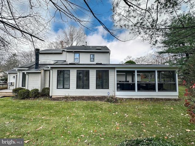 back of property featuring cooling unit, a sunroom, and a lawn