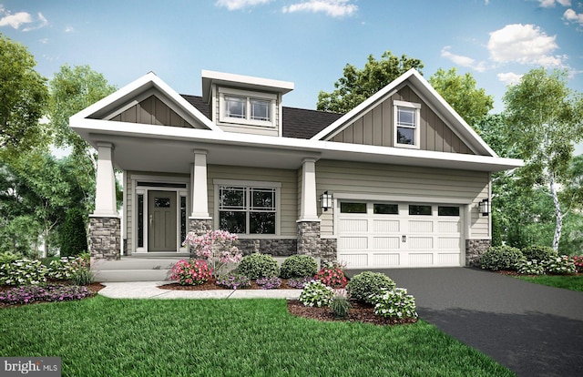 craftsman-style house with covered porch, a front yard, and a garage