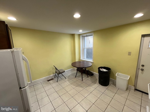 kitchen featuring light tile patterned floors and white fridge