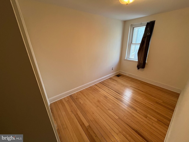 spare room with light hardwood / wood-style flooring