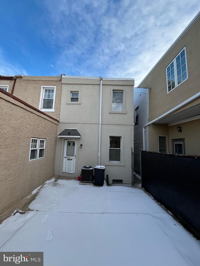 rear view of property with cooling unit