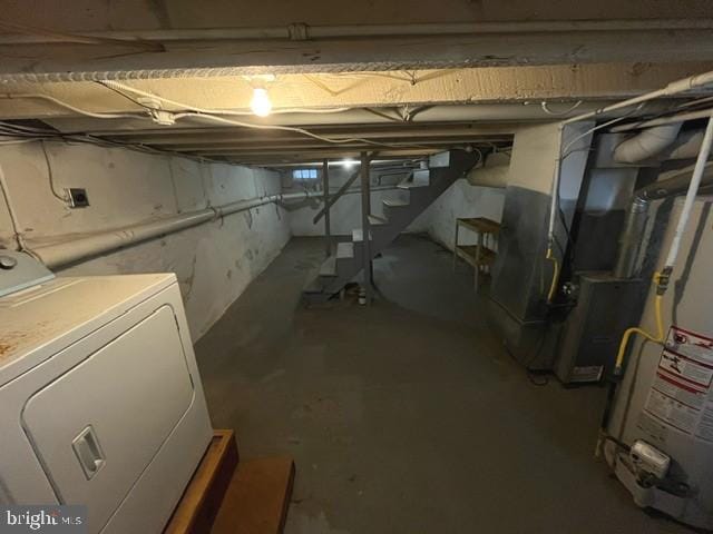 basement featuring washer / clothes dryer and water heater