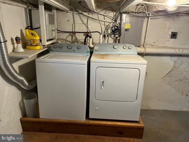 clothes washing area with washer and dryer and electric panel