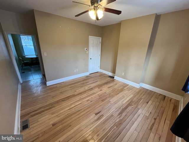 unfurnished room featuring light wood-type flooring and ceiling fan