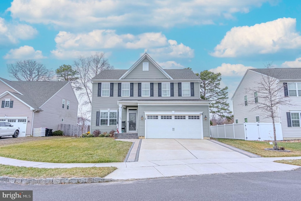 colonial-style house featuring cooling unit, a garage, and a front yard