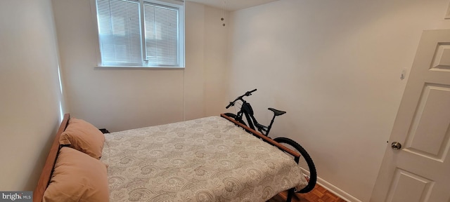 bedroom featuring parquet flooring