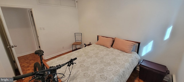 bedroom featuring dark parquet flooring