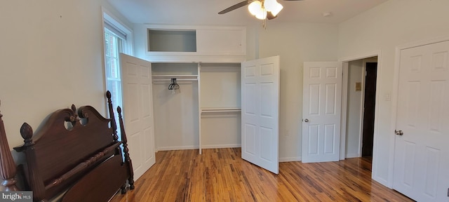 unfurnished bedroom with hardwood / wood-style flooring, ceiling fan, and a closet