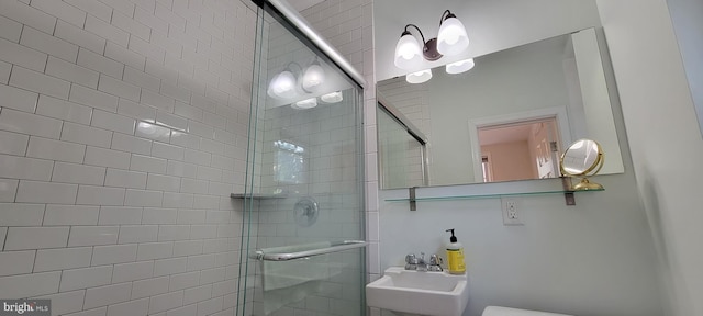 bathroom featuring an enclosed shower, sink, and toilet