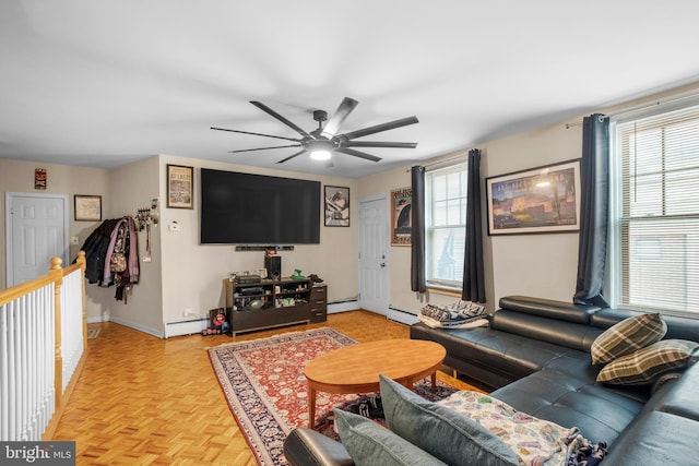 living room with light parquet flooring, a baseboard heating unit, and ceiling fan