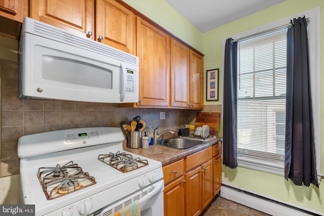 kitchen with a baseboard heating unit, sink, backsplash, and white appliances