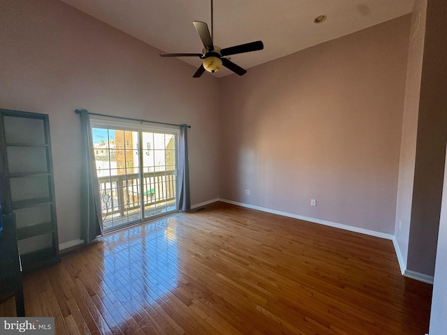 spare room featuring hardwood / wood-style floors, vaulted ceiling, and ceiling fan