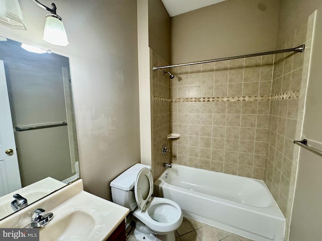 full bathroom featuring tiled shower / bath combo, toilet, tile patterned flooring, and vanity