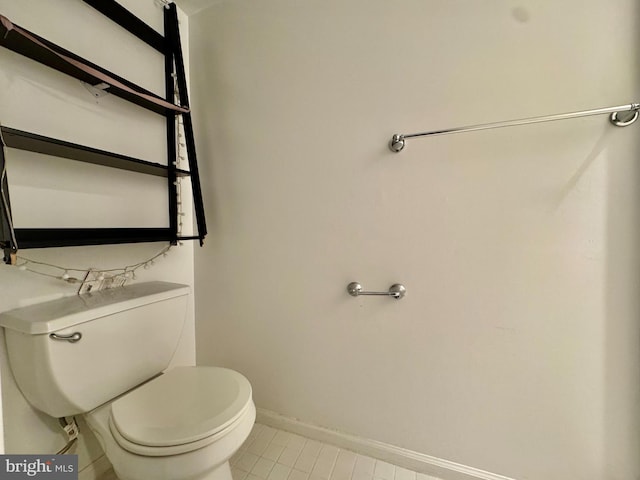 bathroom with toilet and tile patterned floors