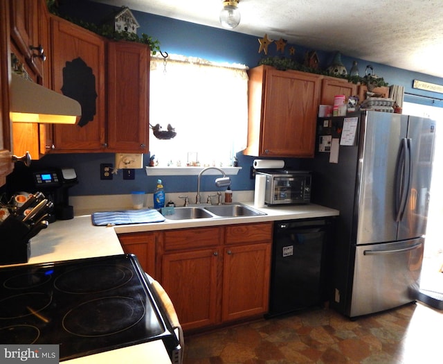 kitchen with electric range oven, a textured ceiling, black dishwasher, sink, and stainless steel fridge