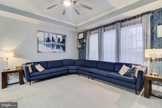 carpeted living room featuring crown molding and ceiling fan