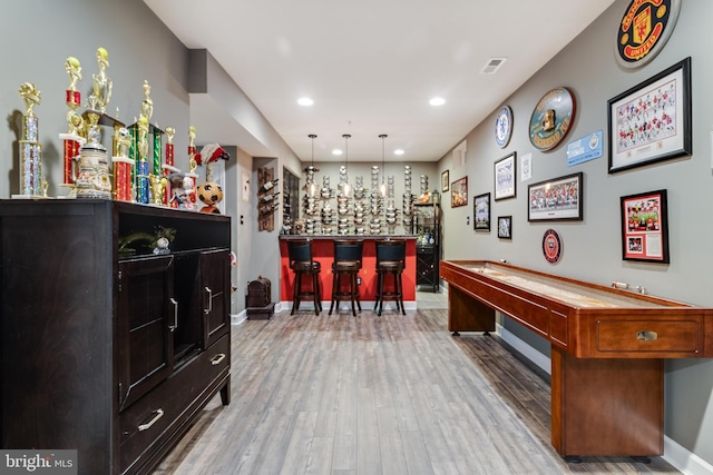 rec room featuring hardwood / wood-style floors and indoor bar