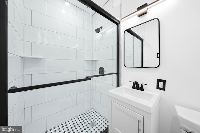 bathroom with sink, toilet, and a tile shower