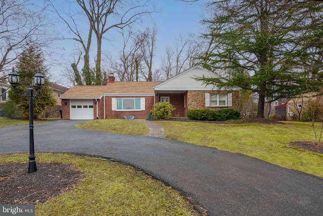 ranch-style home with a garage and a front lawn