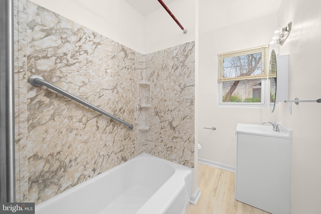 bathroom with hardwood / wood-style floors, shower / tub combination, and vanity