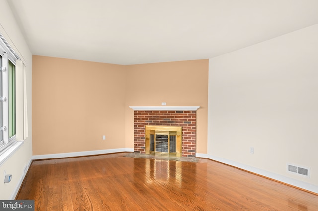 unfurnished living room featuring hardwood / wood-style floors and a fireplace