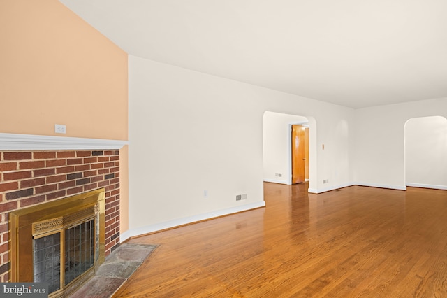 unfurnished living room with a fireplace and wood-type flooring