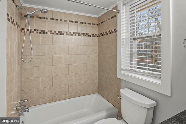 bathroom featuring toilet, ornamental molding, and tiled shower / bath