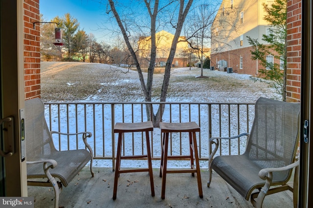 view of snow covered back of property