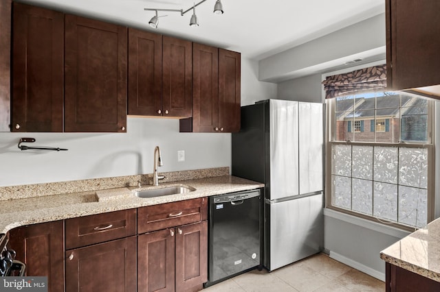 kitchen with sink, a wealth of natural light, stainless steel refrigerator, and black dishwasher