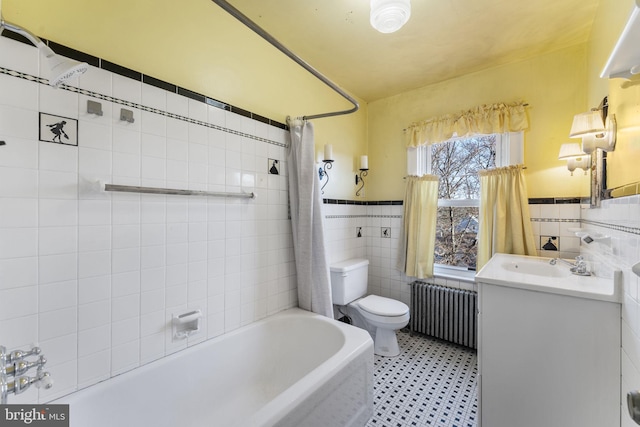 full bathroom with shower / bathtub combination with curtain, tile walls, radiator heating unit, vanity, and toilet