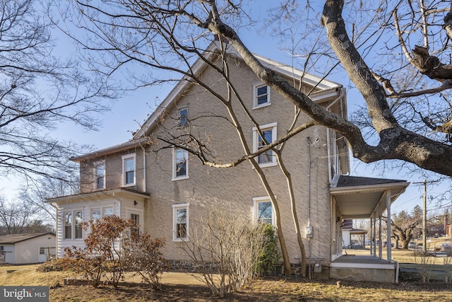 view of side of home with covered porch