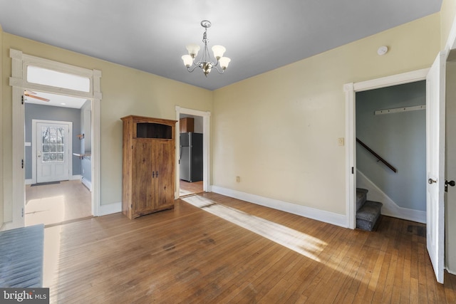 interior space featuring hardwood / wood-style floors and a notable chandelier