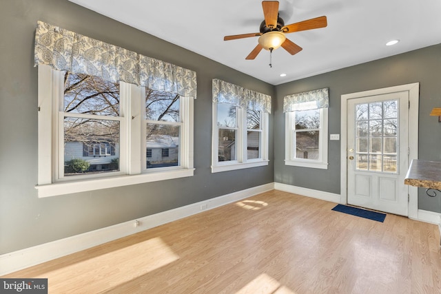 unfurnished sunroom featuring ceiling fan