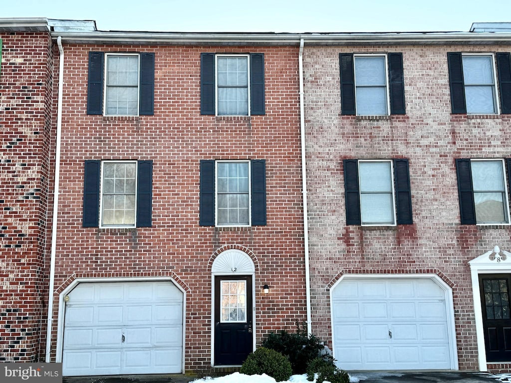 townhome / multi-family property with a garage