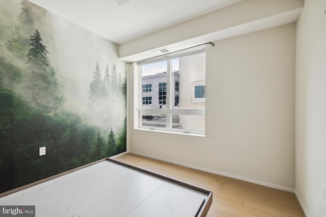 unfurnished room with wood-type flooring