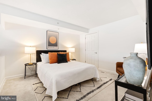 bedroom featuring light colored carpet