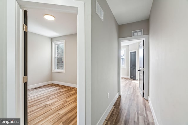 hallway with light hardwood / wood-style flooring