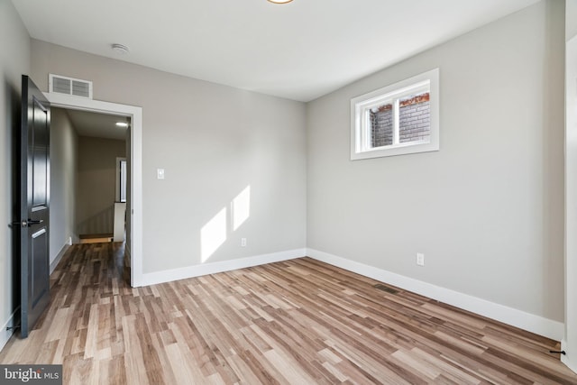 unfurnished room with wood-type flooring