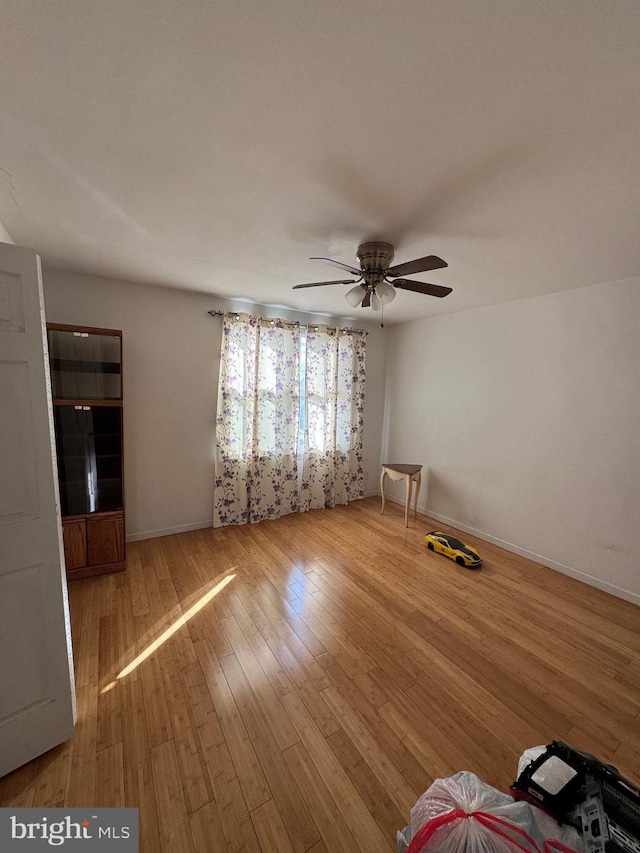 spare room featuring light hardwood / wood-style flooring and ceiling fan