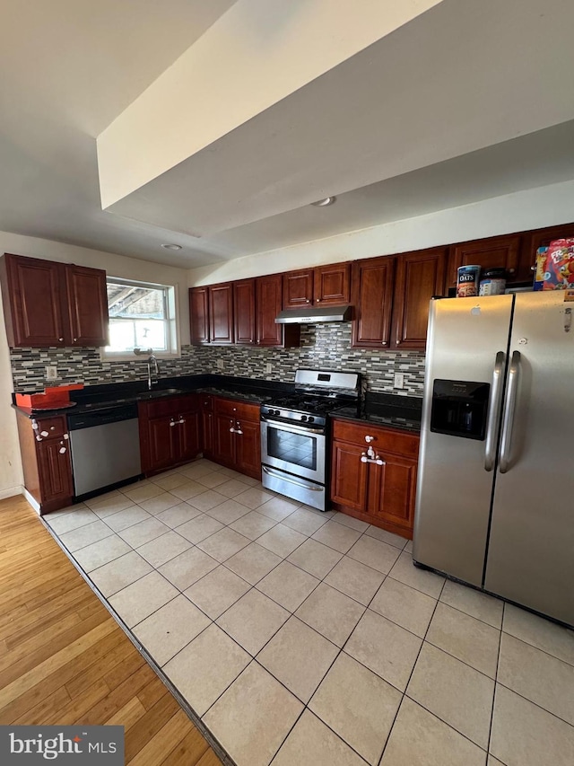 kitchen featuring light tile patterned floors, sink, and appliances with stainless steel finishes