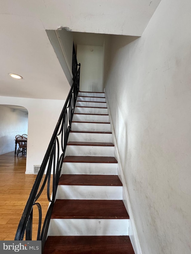 staircase featuring hardwood / wood-style floors